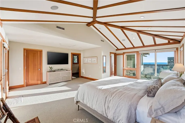 Primary Bedroom with ocean view balcony, and deck with staircase that leads to backyard with jacuzzi.