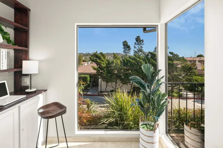 Corner area, makeshift standing desk area, with large window looking East.