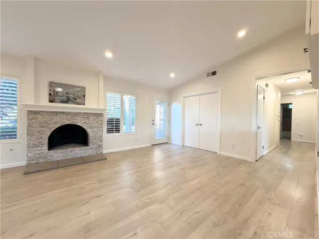 Spacious family room anchored by a cozy fireplace.