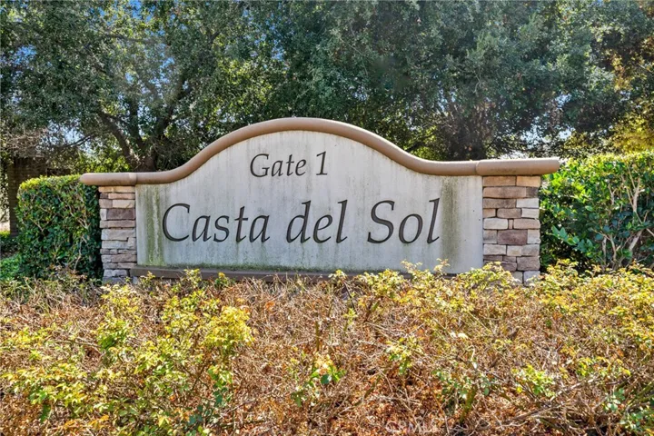 The “Welcome to Casta del Sol” sign sets the tone for this active 55+ neighborhood.