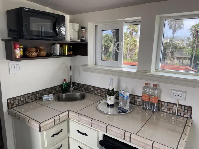 Mini refrigerator, sink, microwave, cabinetry, counter top,