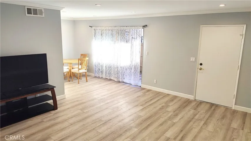 View of living room , dining area and front door