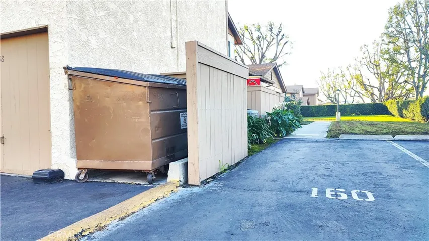 Assigned parking space #160 next to trash bins