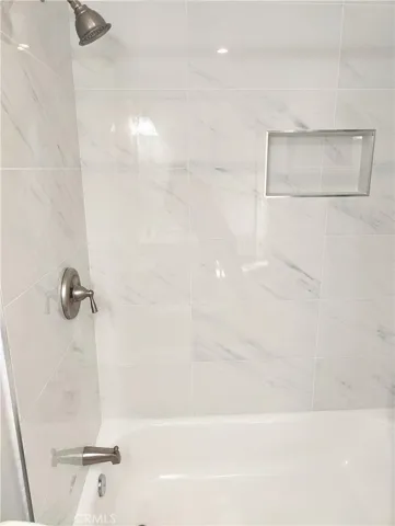 New shower wall, faucet, and tub.