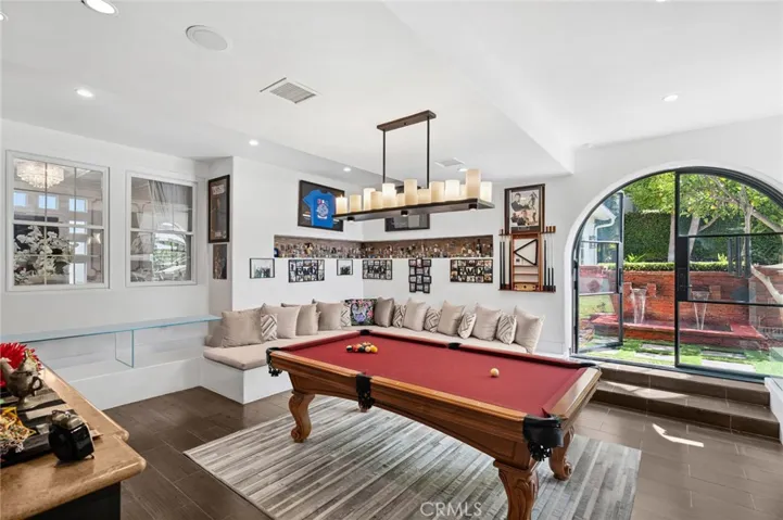 An all-season loggia that opens to the outdoors—ideal as a game room, lounge, or additional gathering space.