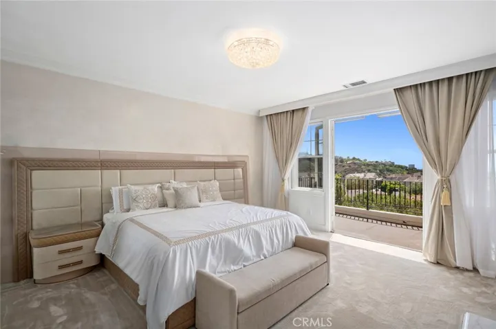 Enjoy a cozy fireplace, boutique-style walk-in closet with illuminated custom built-ins, and a spa- inspired primary bath with dual vanities, a soaking tub, walk-in shower, and a secondary walk-in closet. A private balcony invites you to take in panoramic views— perfect for morning coffee or sunset reflections.