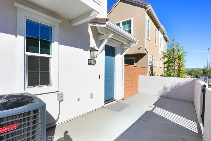 Alternate patio view showing entry door access and exterior lighting.