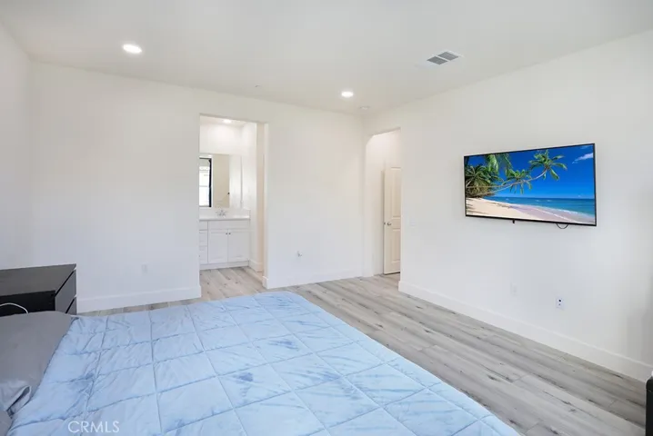 : Primary bedroom view with direct access to en-suite bathroom.