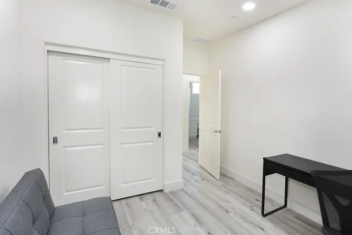 Additional view of bedroom highlighting closet doors and flexible room layout.