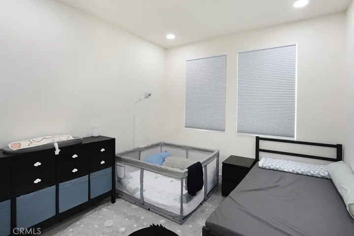 Bedroom with recessed lighting, dual windows, and neutral finishes.
