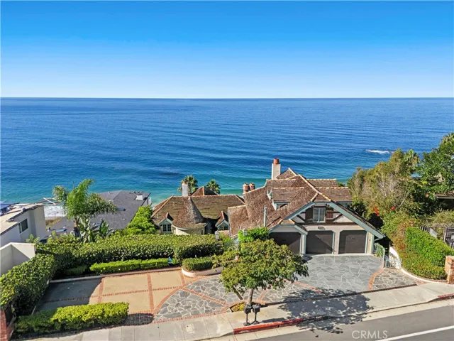 An oversized three-car garage and expansive motor court with a circular drive complete the property. This rare oceanfront compound, where craftsmanship and coastal magic converge, captures the very essence of Laguna Beach living.