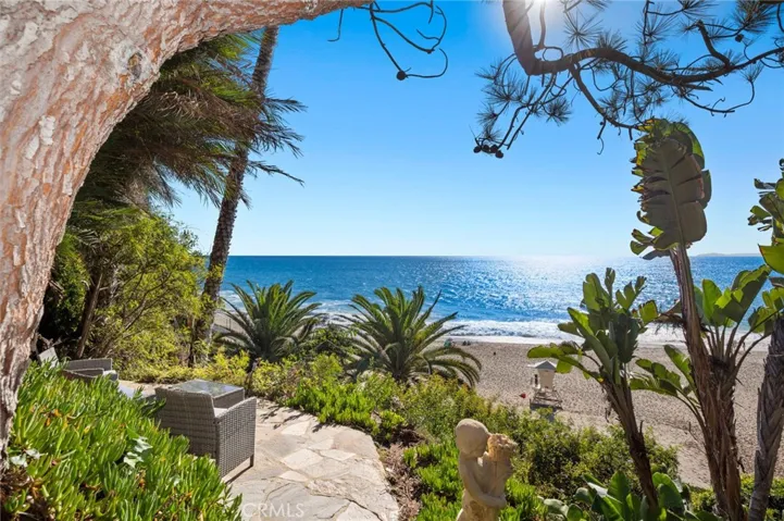 Lush stone pathways meander through the grounds, connecting multiple terraces, a resort-style pool and spa, and the sandy shoreline of renowned Thousand Steps Beach.