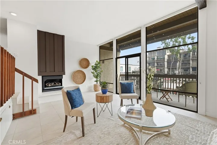 Spacious living room with floor to ceiling windows, fireplace & private waterfront balcony!