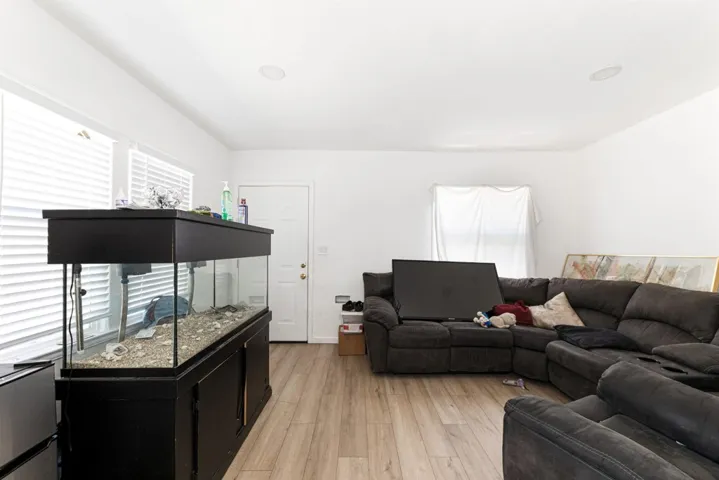 Living room with light wood-style flooring