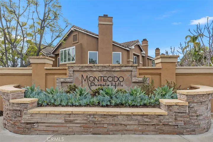 The beautifully designed community entrance features quality stonework.