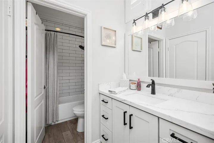 Thoughtfully updated primary bathroom showcasing a stylish walk-in shower n new vanity and fixtures.