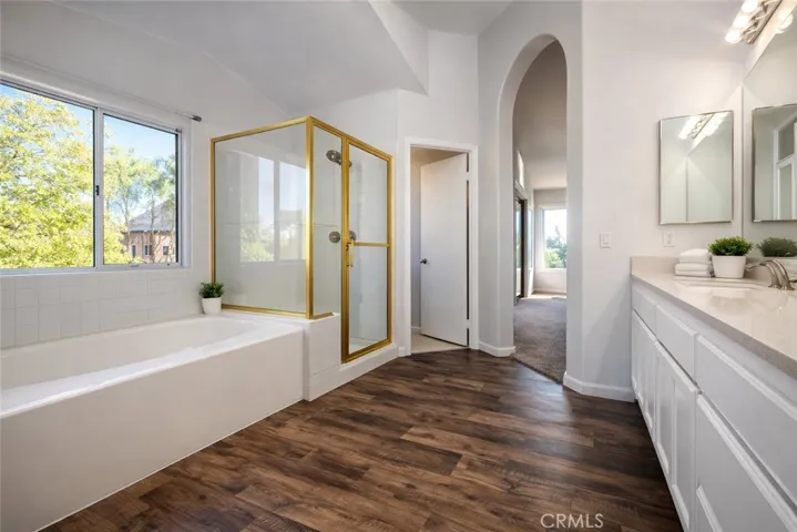 Primary bathroom with Separate tub/Separate shower. Photos have been digitally enhanced,