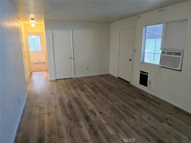 Living room with A/C unit and wall heater