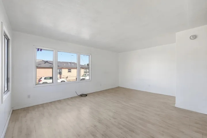 Empty room featuring light wood-style flooring and baseboards