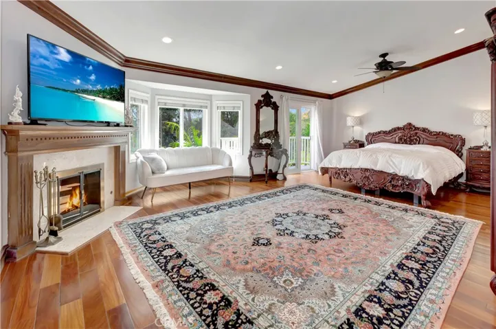 Expansive primary bedroom w/stunning views & cozy fireplace.