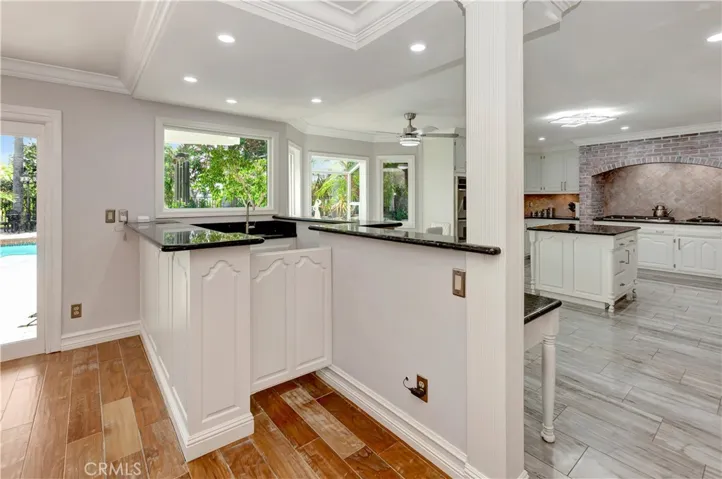 Charming bar conveniently situated between the kitchen &backyard sliding doors.