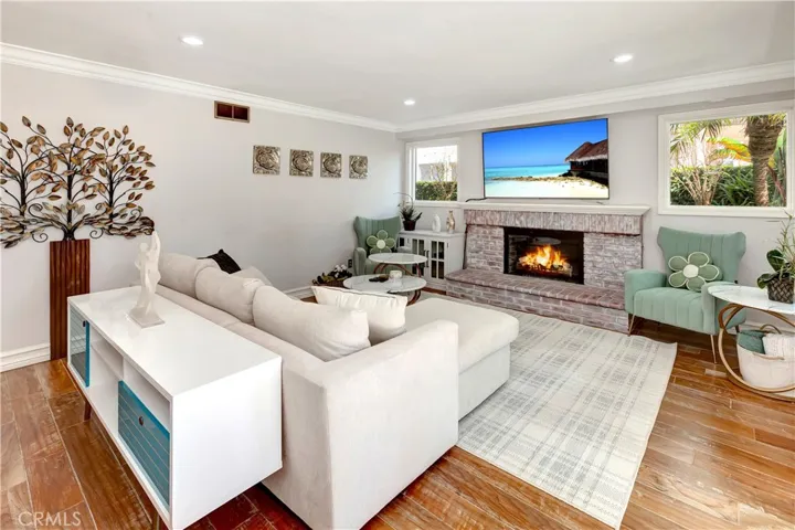 A cozy fireplace enhances the warm amiance of this elegant,comfortable family room.