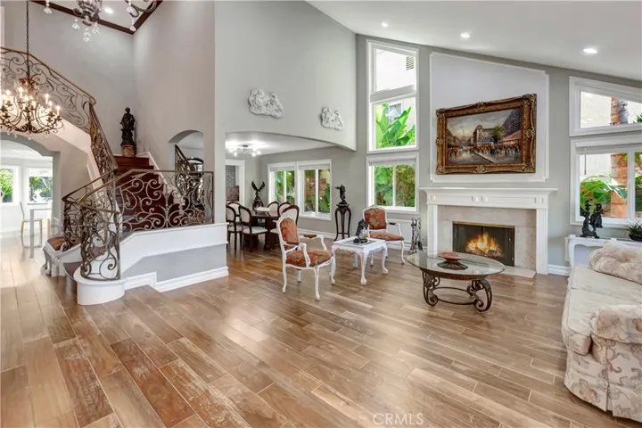 Open iving room- charming fireplace-vaulted ceiling-quality distressed wood flooring through-out.