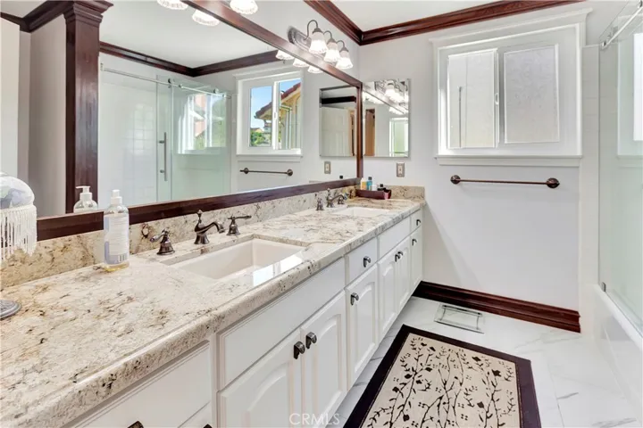Upstairs remodeled bathroom w/double sinks.