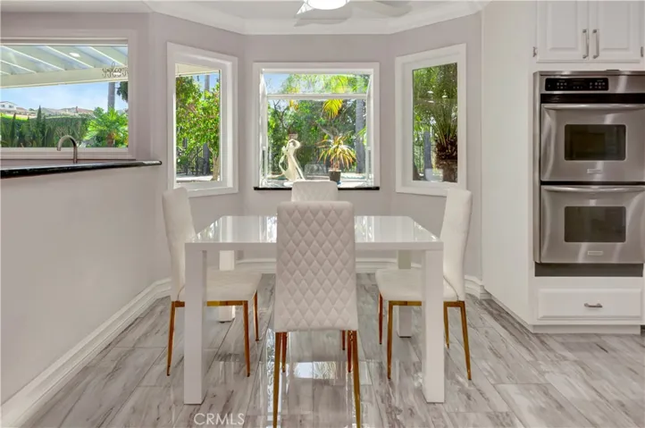 Breakfast nook next to   the bar area- flooded w/ natural light & stunning views.