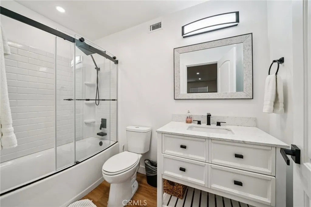 Fresh, modern full bath with quartz-top vanity, subway-tile tub/shower, and matte-black fixtures.