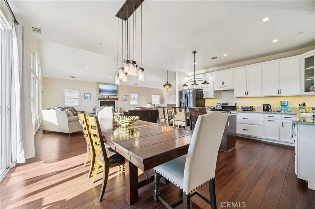 Sunlit space off the deck with statement pendant lighting and room for a large table.