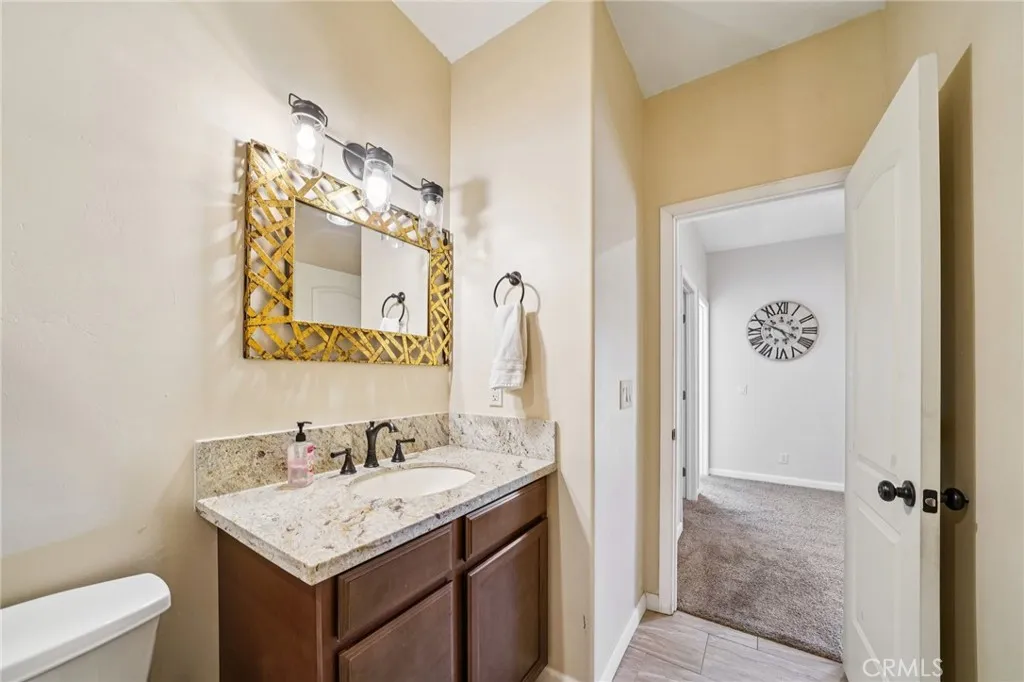 Granite-topped vanity with framed mirror and ample storage