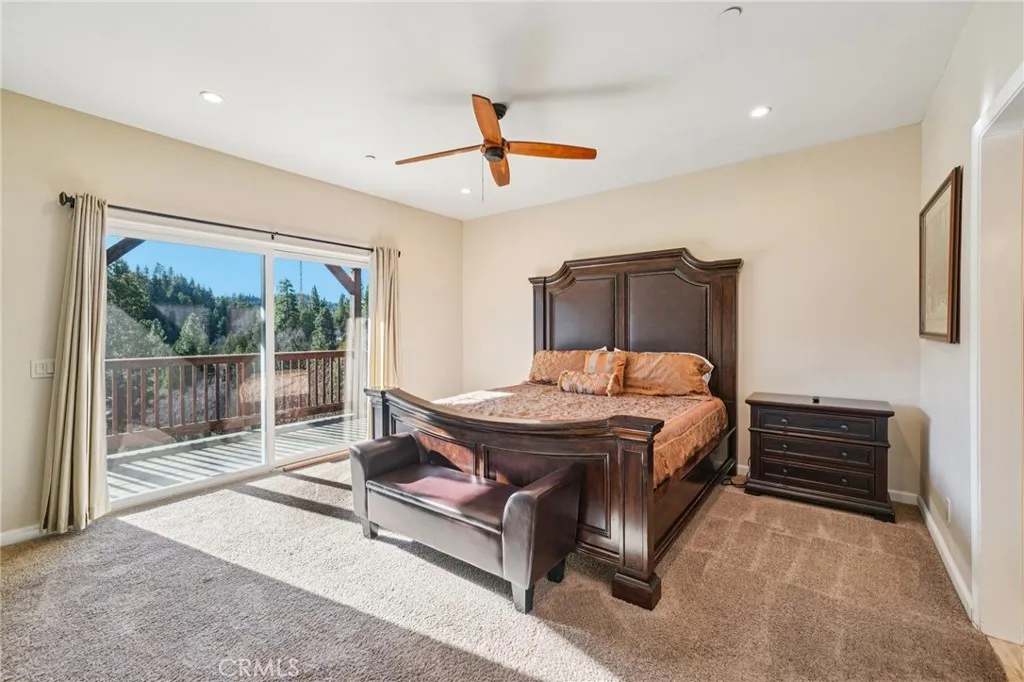 Spacious retreat with slider to the deck and soothing treetop views.
