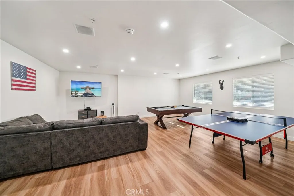 Oversized rec room with media wall, pool table, and ping-pong—perfect for entertaining.