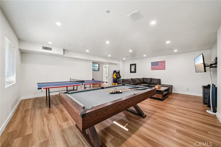 Pool and ping-pong tables with sectional seating and TV—made for fun.