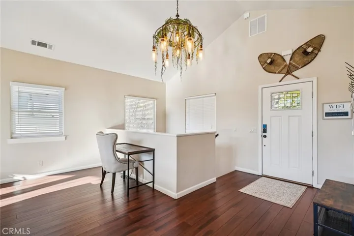 Bright landing with statement chandelier—ideal as a small desk/command center.