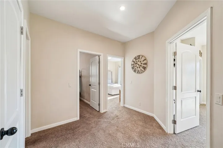 Carpeted landing connecting secondary bedrooms and bath.