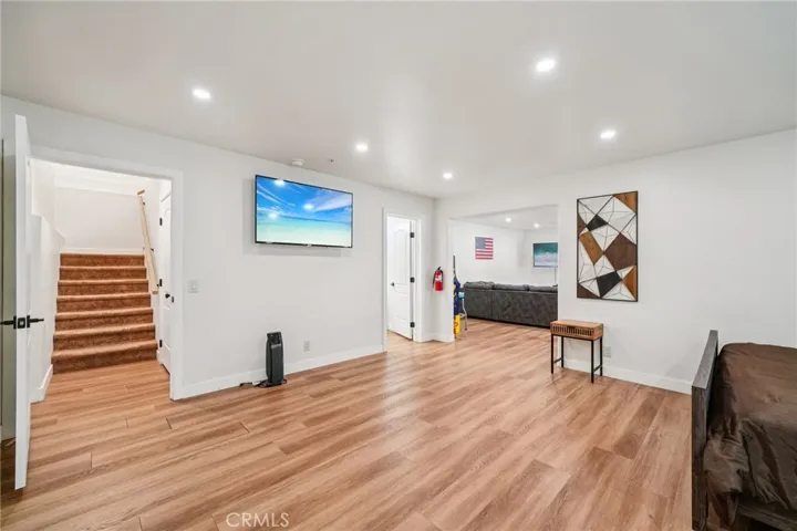 Wide circulation area with TV; easy flow to game lounge and stairway up.