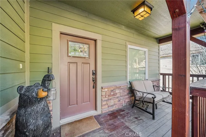 Welcoming porch with stone accents and space for a bench—great drop zone before heading inside.