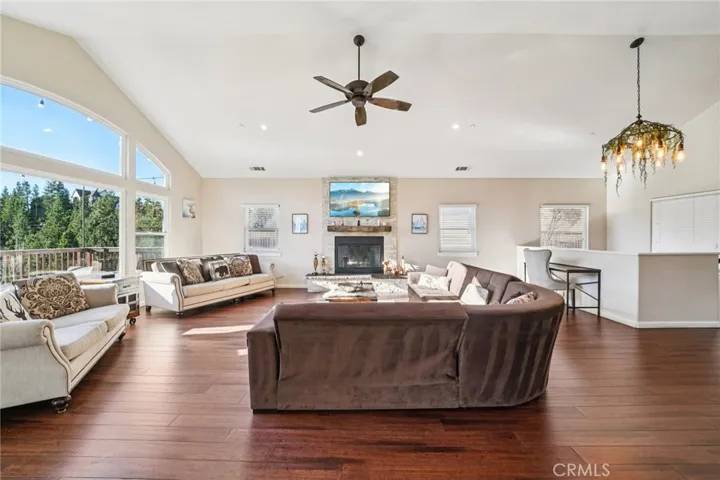 Vaulted ceilings and wide-plank floors anchor an airy, open-concept layout with flexible seating and workspace.
