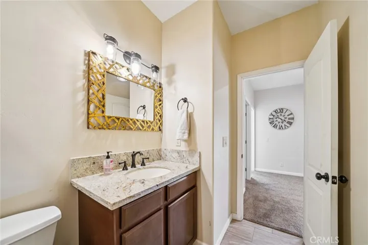 Granite-topped vanity with framed mirror and ample storage