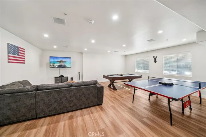 Oversized rec room with media wall, pool table, and ping-pong—perfect for entertaining.