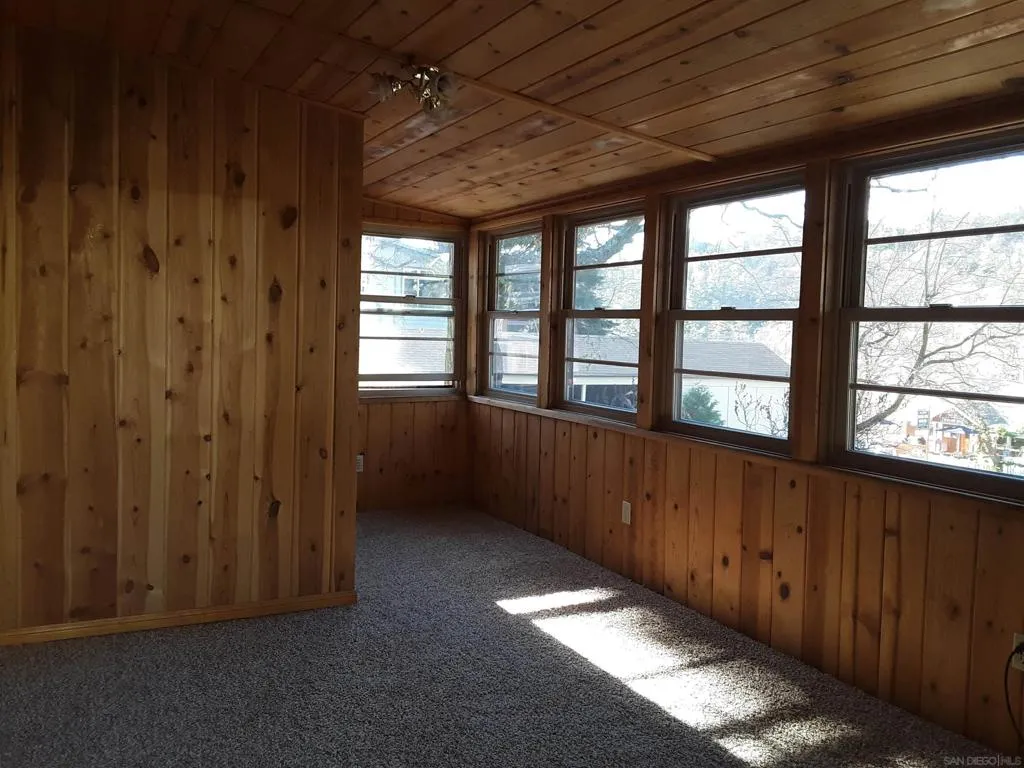 Sunny, enclosed porch of house.