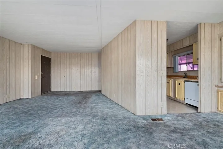 Living room facing kitchen and front door