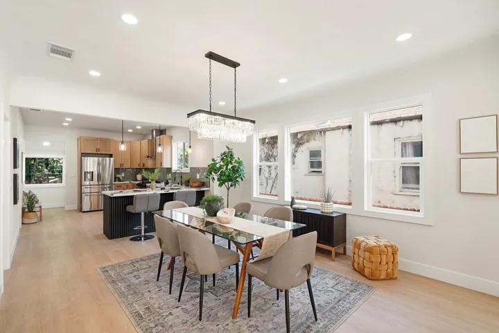 Dining area with light wood finished floors, recessed lighting, healthy amount of natural light, and a chandelier
