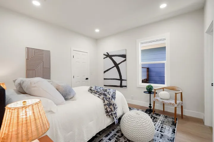 Bedroom with wood finished floors and recessed lighting