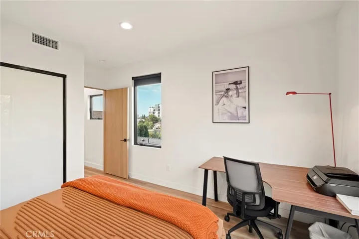 Third bedroom with fluted solid wood door, generous closet space with frosted glass and picture windows
