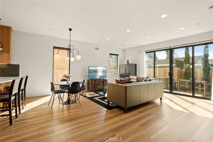 Open concept living room with large picture windows and access to private backyard