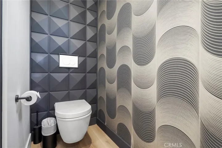 Main floor powder room with a floating tankless toilet