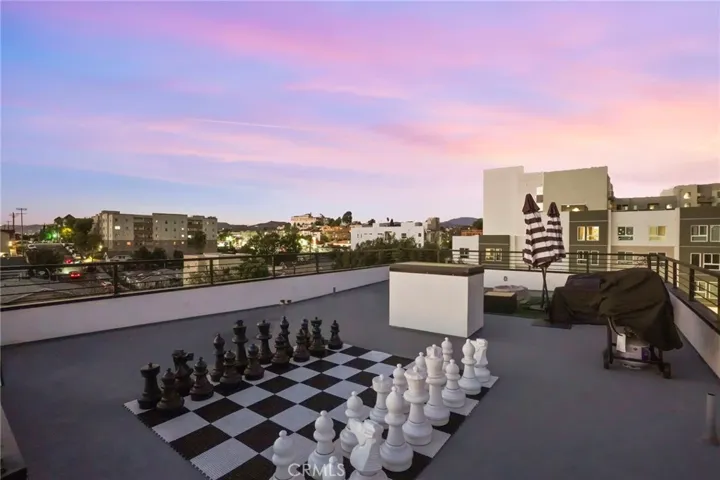 Twilight shot of the roof deck with rooftop chess